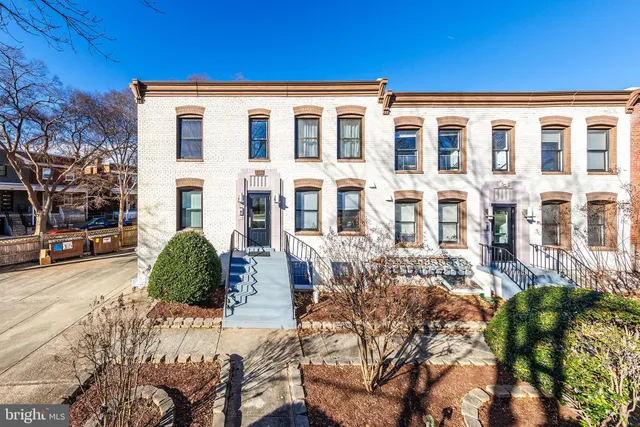 a front view of a building with a yard