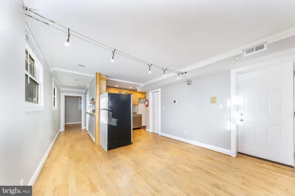 a view of a livingroom with wooden floor and a ceiling fan