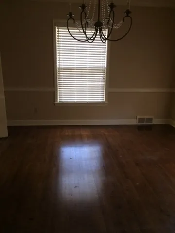a view of room with hardwood floor and window