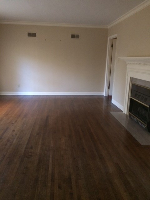 5177 Walnut Grove Road Memphis, TN 38117 - Photo 4 of 6 a view of empty room with wooden floor and fireplace