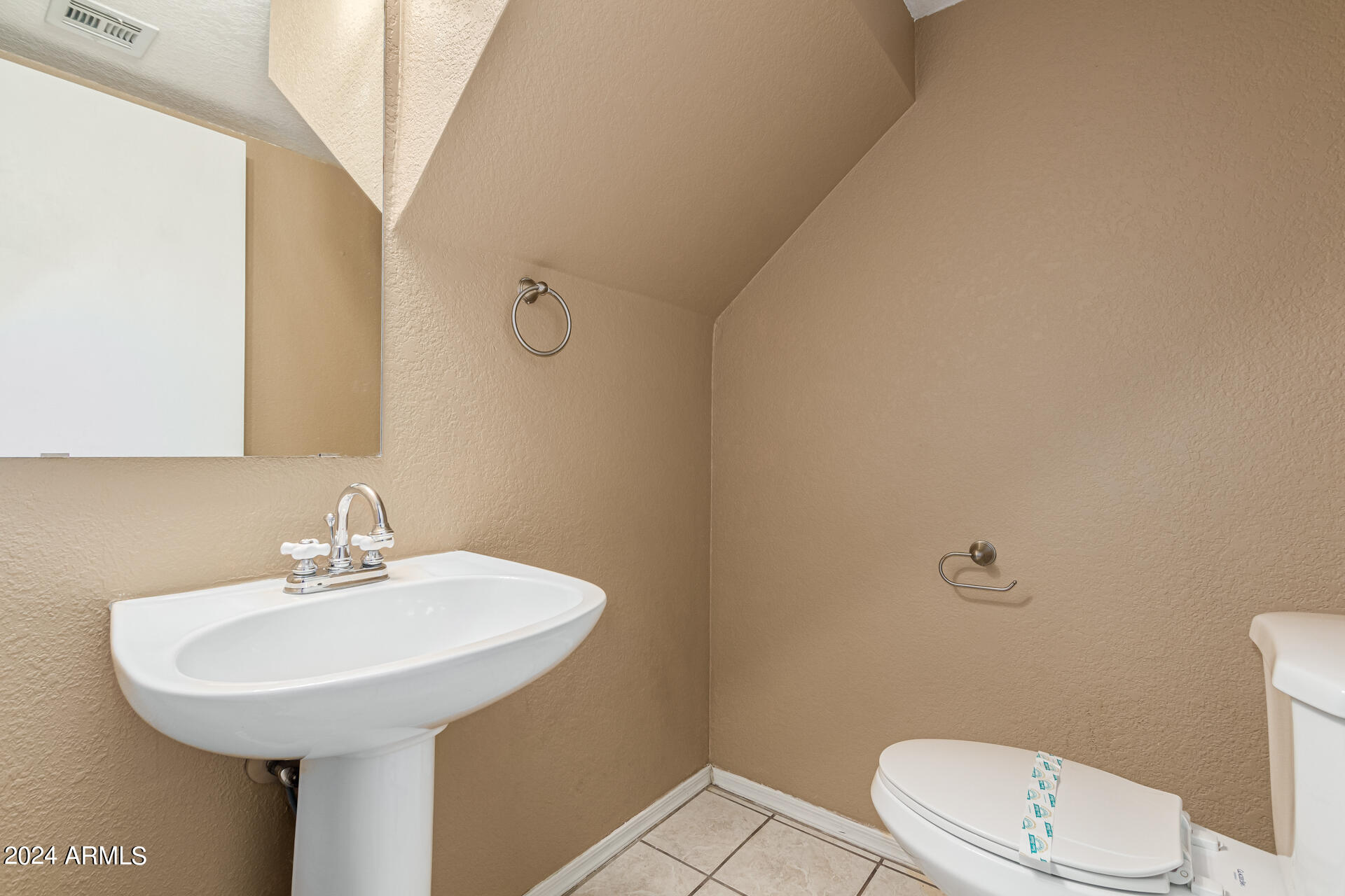 1371 South Boulder Street, Unit A Gilbert, AZ 85296 - Photo 19 of 43 a bathroom with a sink a toilet and a mirror