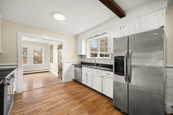 a kitchen with granite countertop a refrigerator and a stove top oven