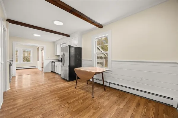 a view of a kitchen with furniture and wooden floor