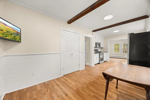 a view of kitchen with furniture and wooden floor