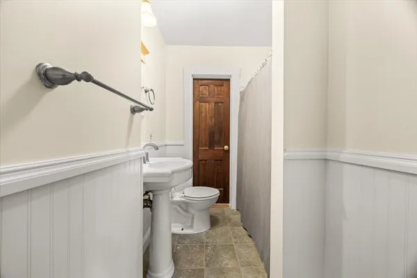 a bathroom with a toilet and a shower