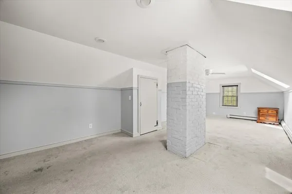 an empty room with entrance and windows