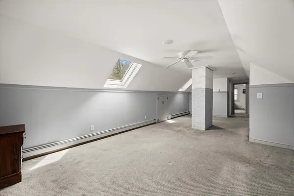 an empty room with a ceiling fan and window