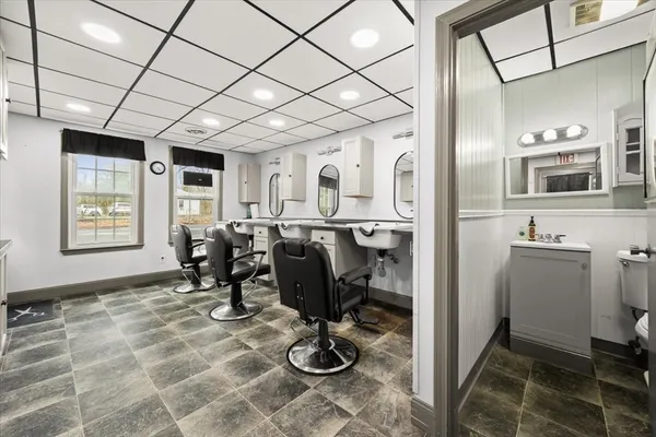 a living room with furniture a flat screen tv and gym equipment
