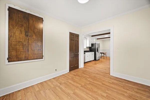 a view of a room with wooden floor and a window