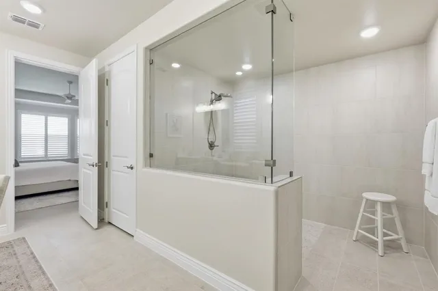 a spacious bathroom with a double vanity sink and a mirror
