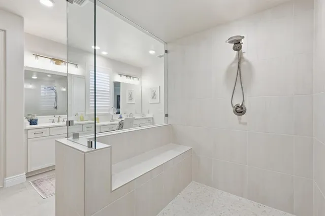 a bathroom with a glass shower door and a sink