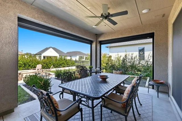a view of an outdoor dining space with a table and chairs