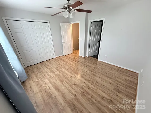 an empty room with windows and closet