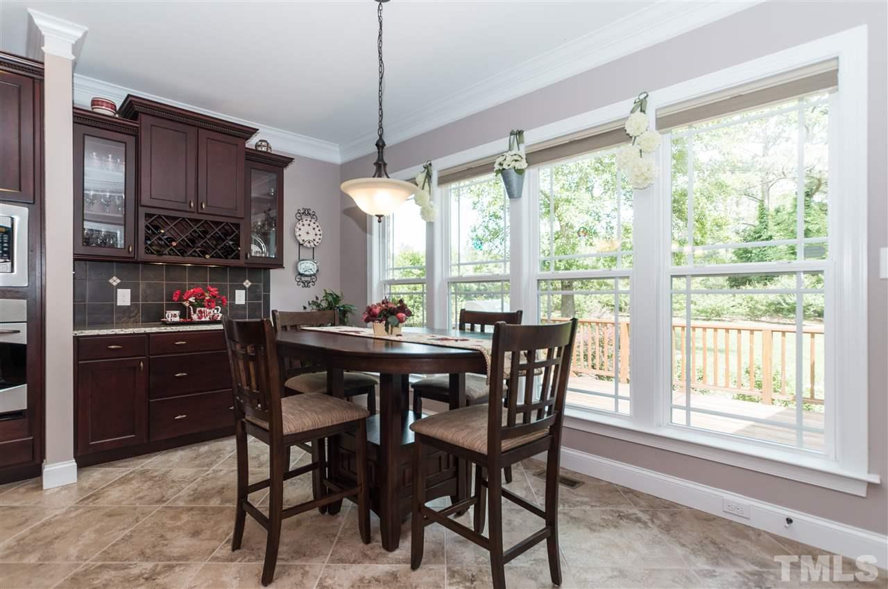 4805 Stoneyoak Lane Raleigh, NC 27610 - Photo 11 of 25 a dining room livingroom with furniture window and wooden floor