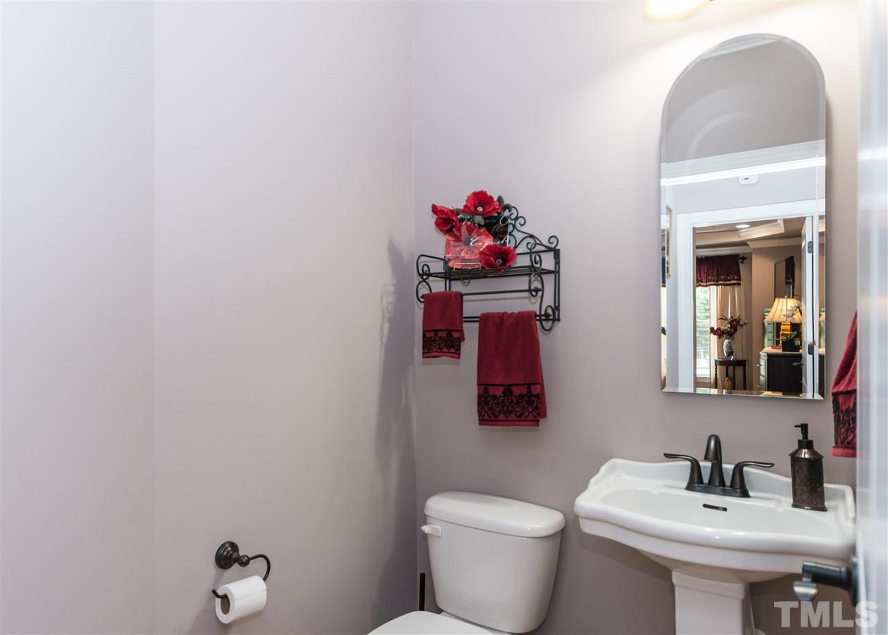 4805 Stoneyoak Lane Raleigh, NC 27610 - Photo 12 of 25 a bathroom with a toilet sink and mirror