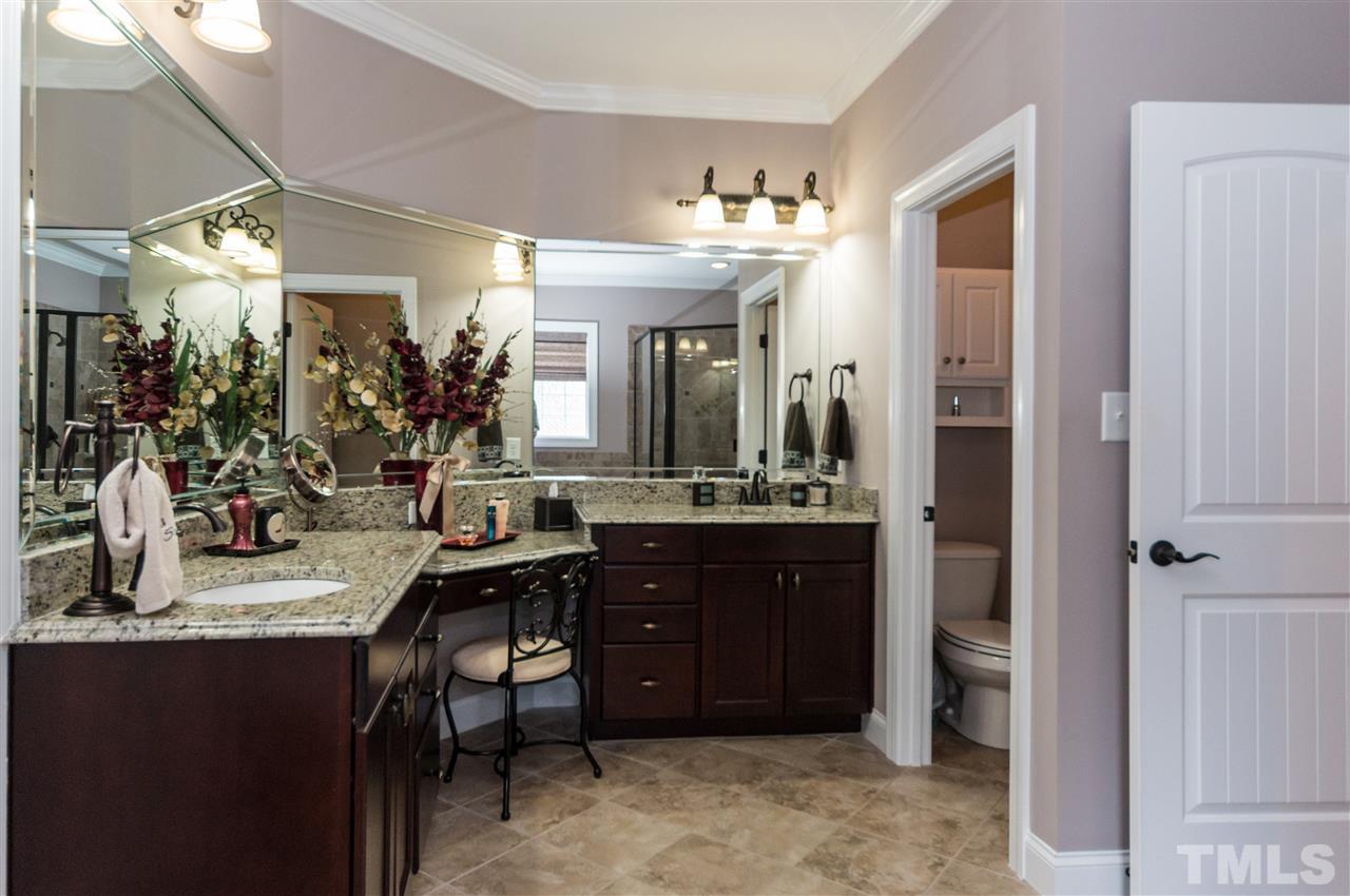 4805 Stoneyoak Lane Raleigh, NC 27610 - Photo 15 of 25 a view of a bathroom with sink and mirror