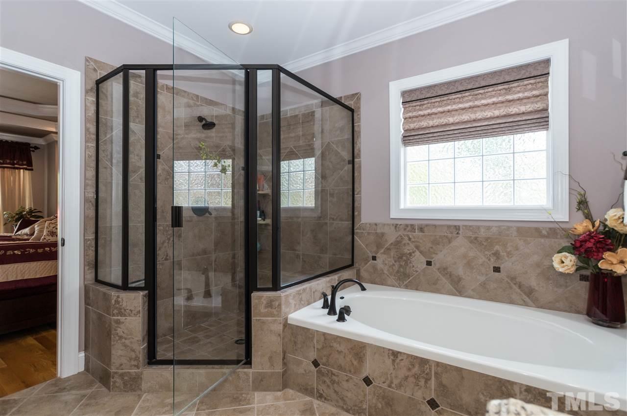 4805 Stoneyoak Lane Raleigh, NC 27610 - Photo 16 of 25 a bathroom with a tub shower and sink