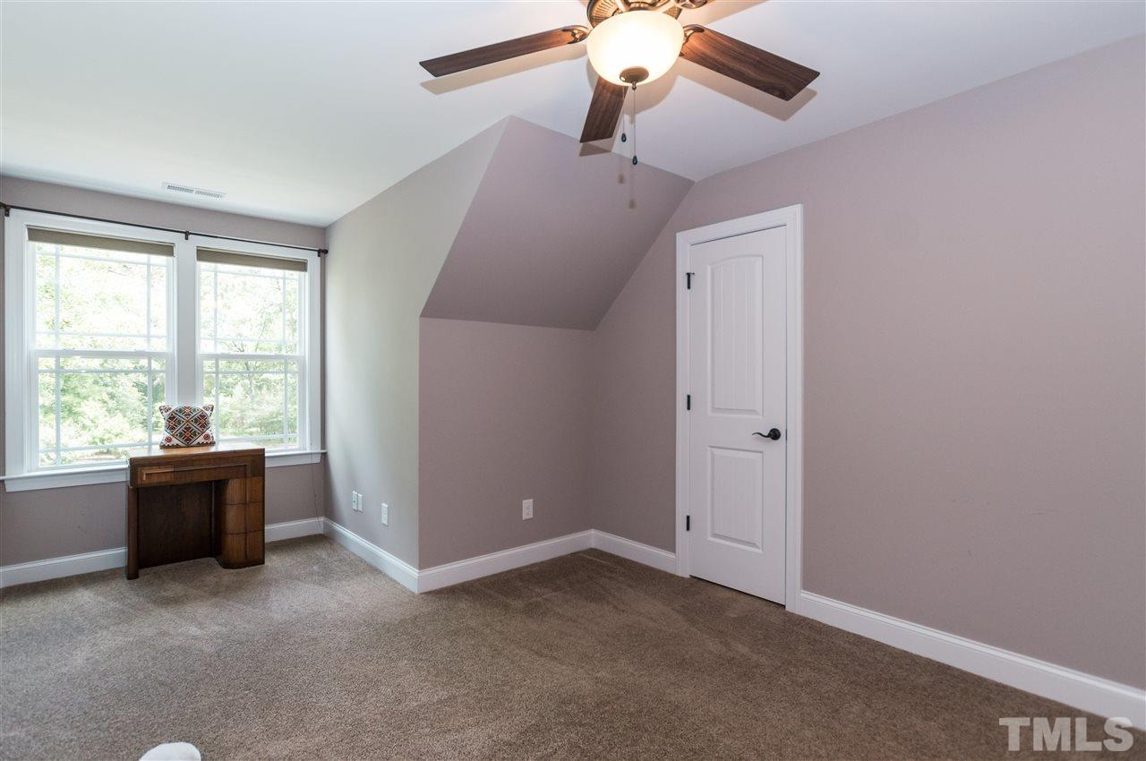 4805 Stoneyoak Lane Raleigh, NC 27610 - Photo 17 of 25 an empty room with windows and ceiling fan