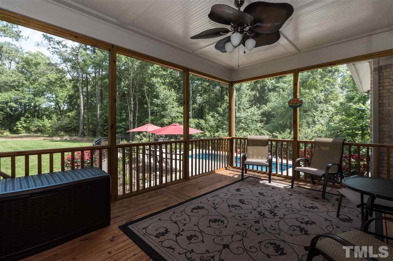 4805 Stoneyoak Lane Raleigh, NC 27610 - Photo 22 of 25 a view of a porch with furniture and wooden floor