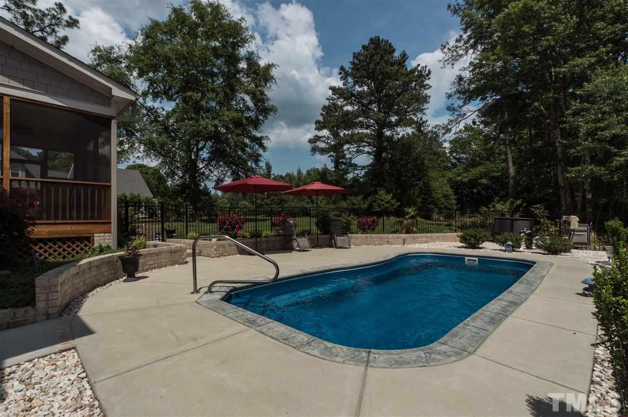 4805 Stoneyoak Lane Raleigh, NC 27610 - Photo 23 of 25 a swimming pool with outdoor seating and yard