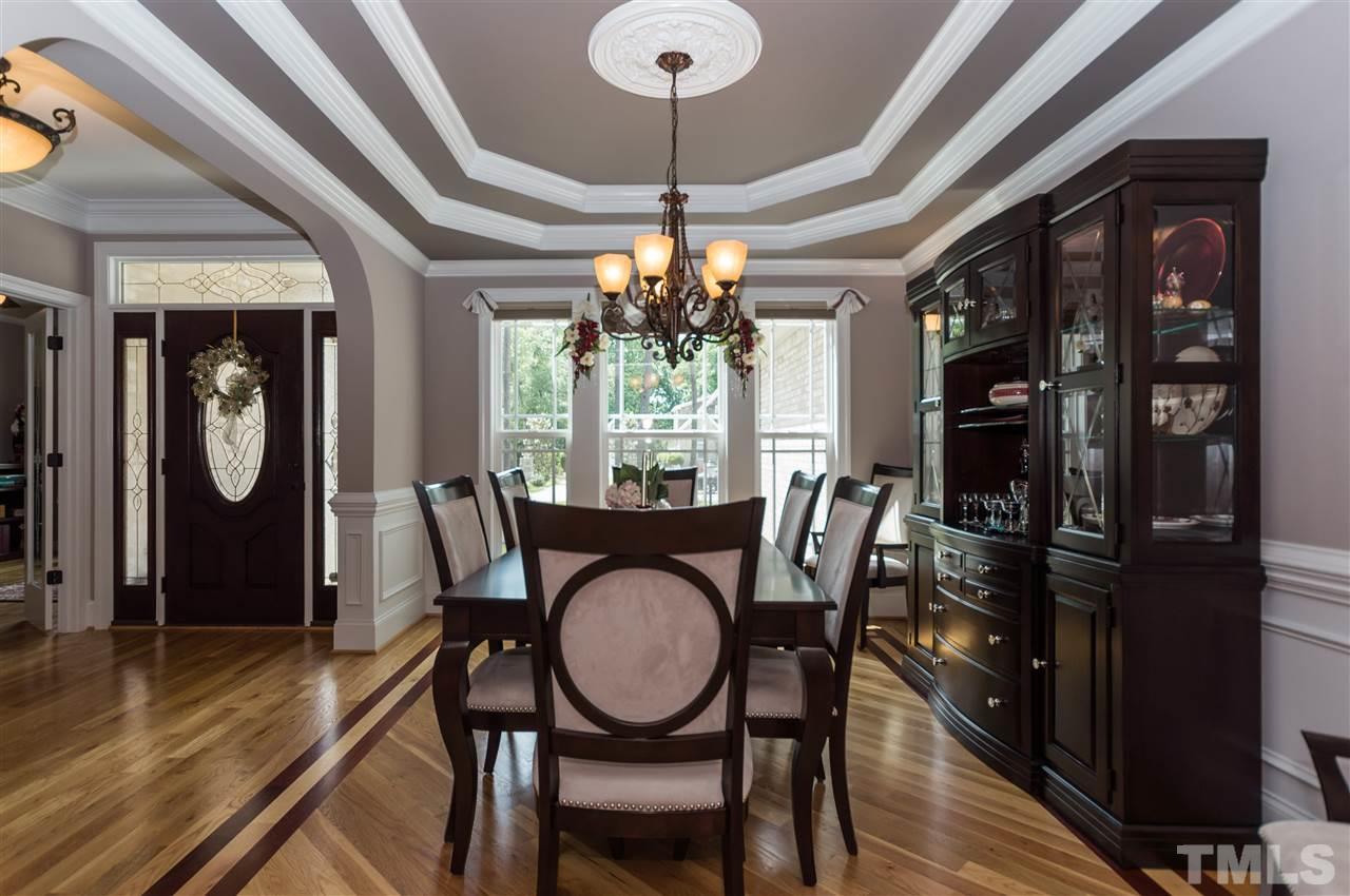 4805 Stoneyoak Lane Raleigh, NC 27610 - Photo 4 of 25 a dining room with furniture a chandelier and wooden floor