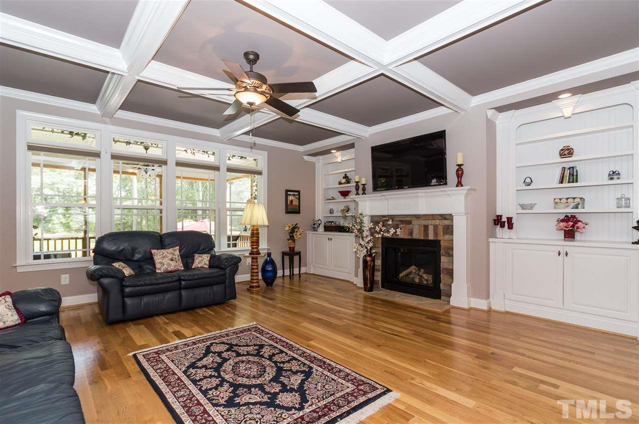 4805 Stoneyoak Lane Raleigh, NC 27610 - Photo 6 of 25 a living room with furniture a flat screen tv and a fireplace