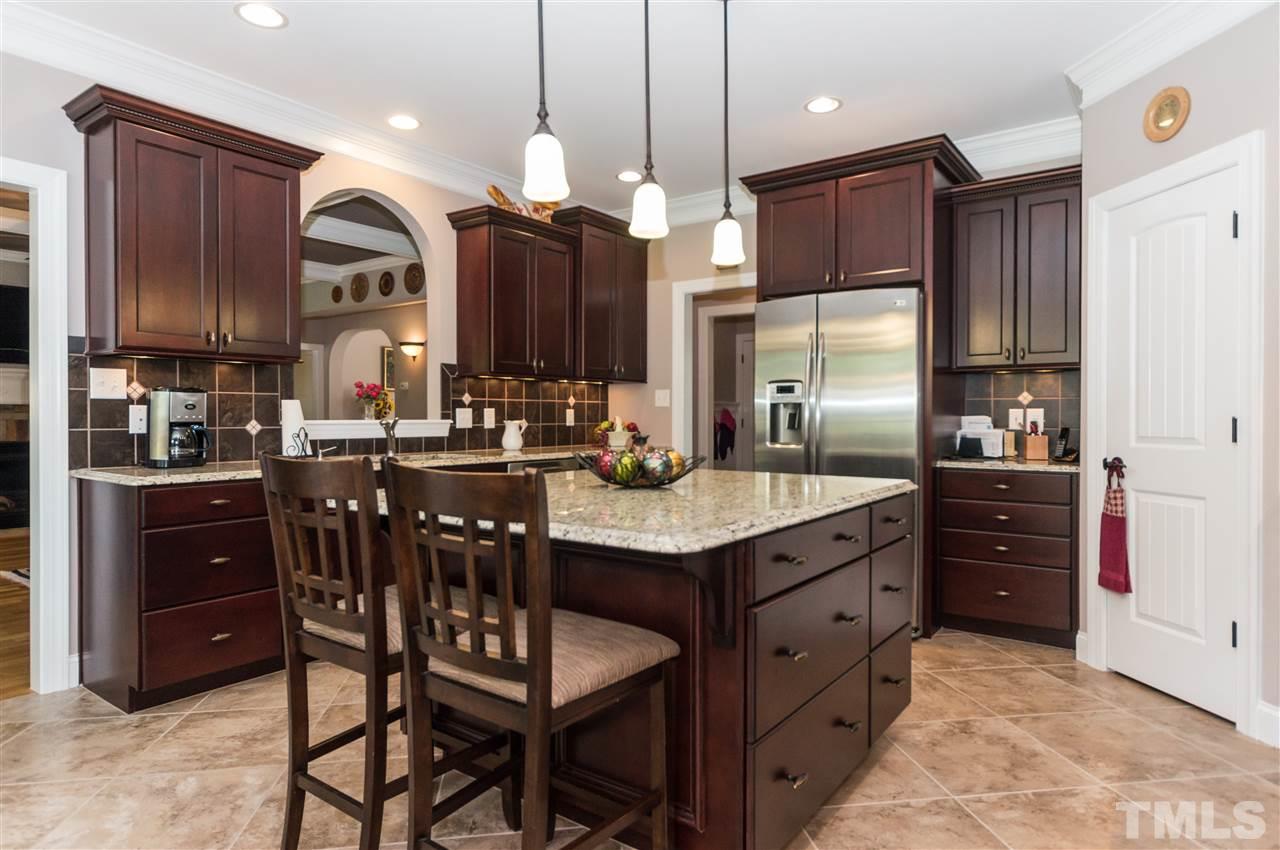 4805 Stoneyoak Lane Raleigh, NC 27610 - Photo 8 of 25 a kitchen with granite countertop a sink cabinets and stainless steel appliances