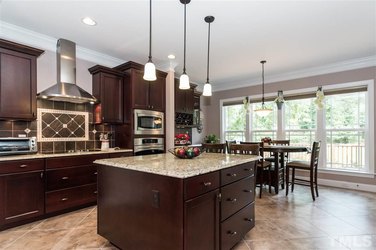 4805 Stoneyoak Lane Raleigh, NC 27610 - Photo 10 of 25 a kitchen with center island and a table