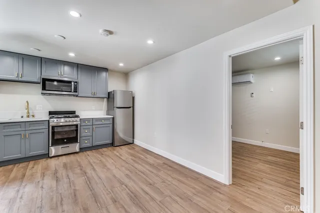 a kitchen with stainless steel appliances a refrigerator and a stove top oven