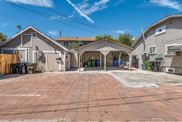 a patio with a table and chairs under an umbrella