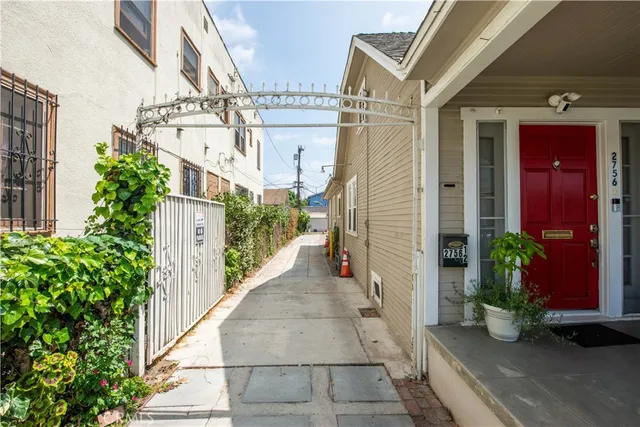 a view of a pathway along the path along with potted plants