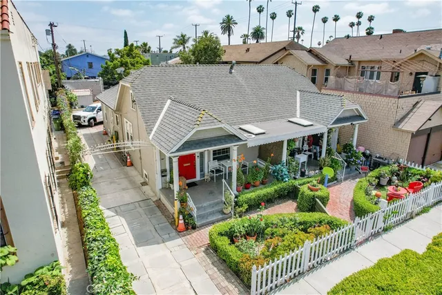 a aerial view of a house with a yard and potted plants