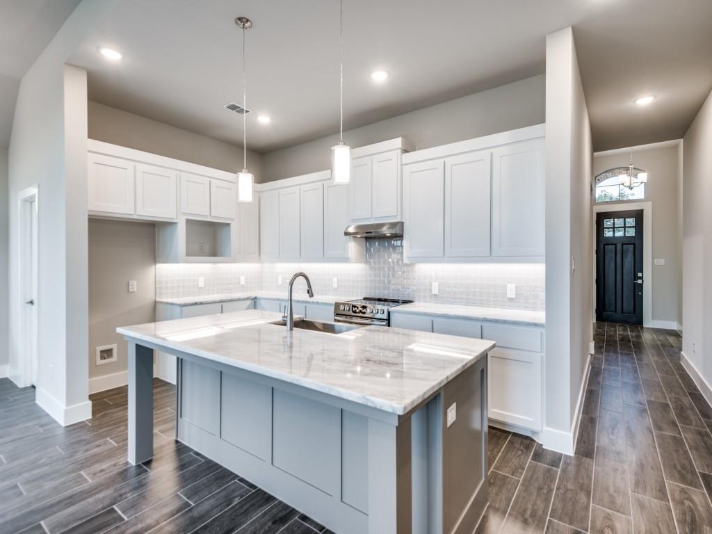 139 Lakeview Circle Pilot Point, TX 76258 - Photo 1 of 19 Kitchen with wood tiled floor, visible vents, under cabinet range hood, and a sink