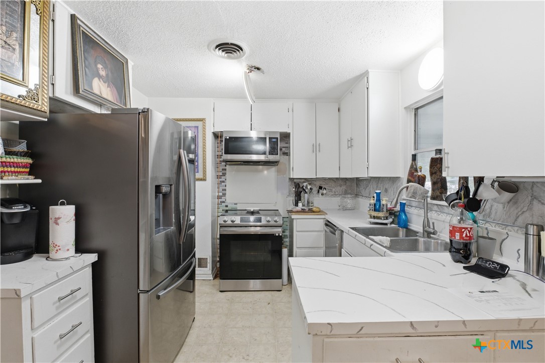 503 Cardinal Avenue Killeen, TX 76541 - Photo 11 of 26 a kitchen with stainless steel appliances granite countertop a refrigerator sink stove and oven