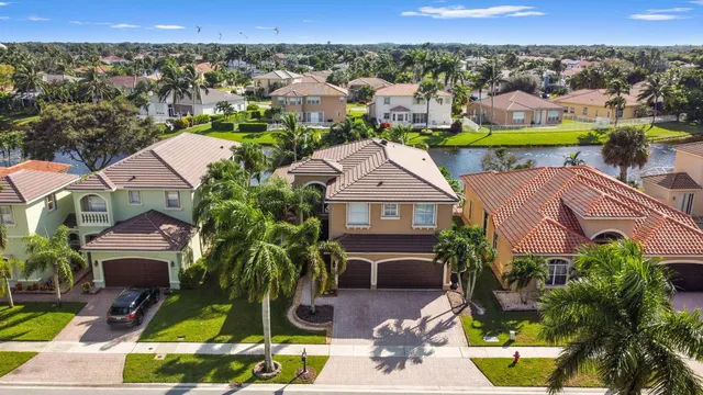 an aerial view of residential houses with outdoor space and swimming pool