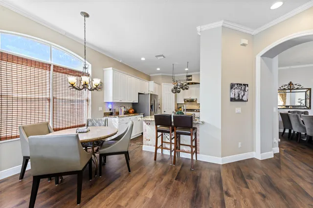 a kitchen with stainless steel appliances granite countertop a sink cabinets and wooden floor