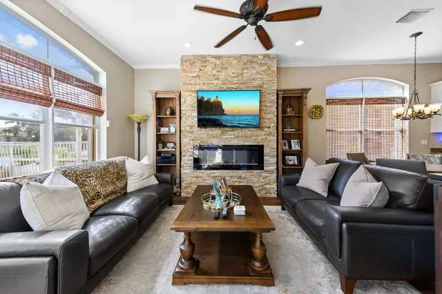 a living room with furniture a fireplace and a flat screen tv