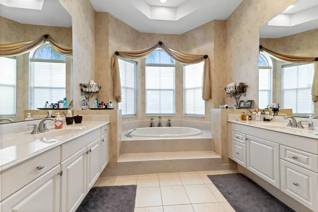 a large bathroom with a double vanity sink mirror and shower