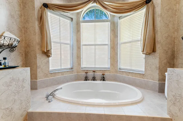 a kitchen with stainless steel appliances granite countertop a stove a refrigerator and a dining table