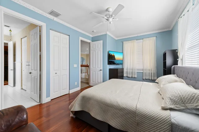 a bedroom with a bed and a lamp on the dresser