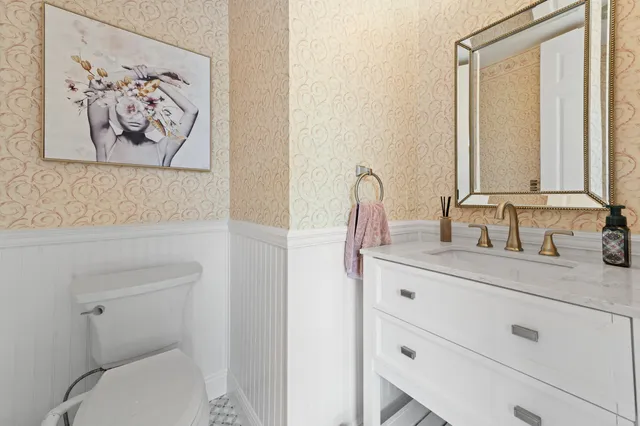 an aerial view of residential houses with outdoor space and lake view