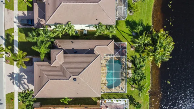 an aerial view of residential houses with outdoor space and swimming pool