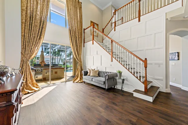 a living room with furniture and a floor to ceiling window