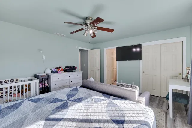 a bedroom with a bed and a chandelier