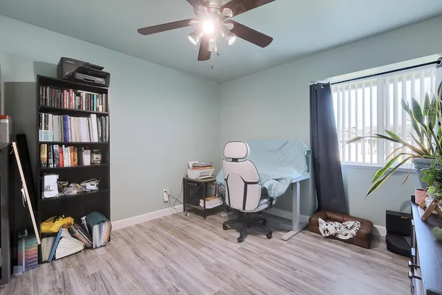 a living room with furniture and a book shelf