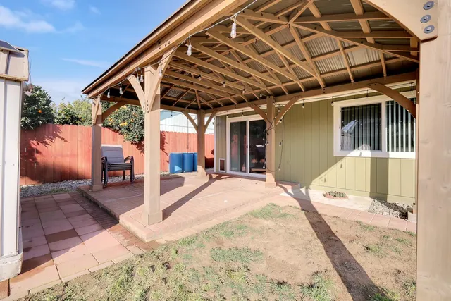 a view of a porch with furniture and a yard