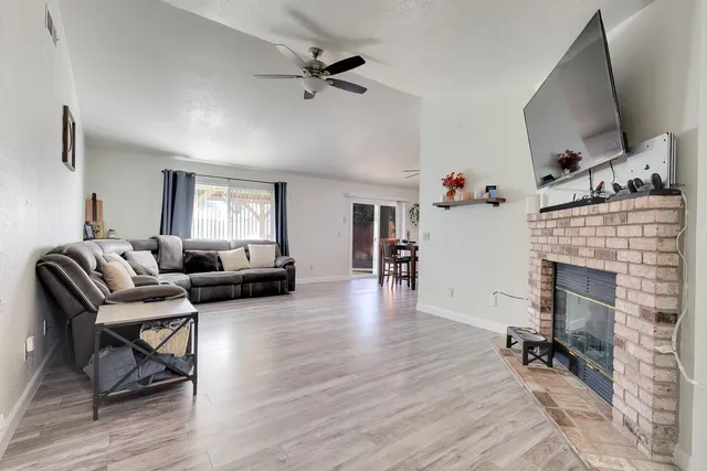 a living room with furniture and a fireplace