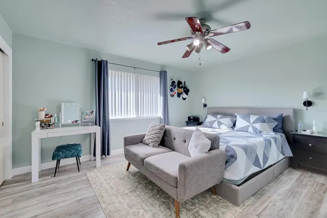 a bedroom with bed and a table