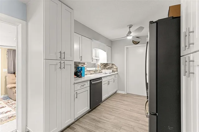 a kitchen with white cabinets and white appliances