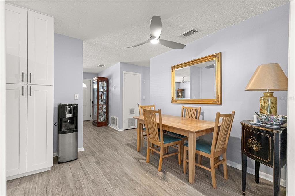 810 Northeast 44th Street Ocala, FL 34479 - Photo 13 of 44 a view of a dining room with furniture and wooden floor